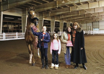 Horse presentations are a common part of barn holiday parties. In 2014, Sara Evans received CH Keeper Of The Stars at the High Caliber party. 