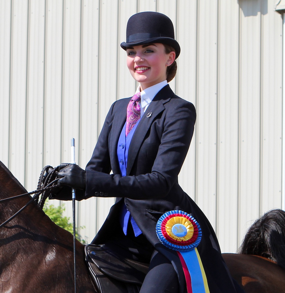 Taylor Pszeniczny in a custom made dark navy suit with a pop of color to complement her complexion. Photo by Dallys Malenfant.